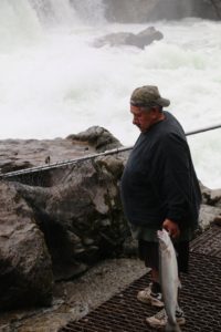 First Nations fisherman with salmon
